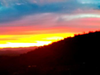 Scenic view of dramatic sky during sunset