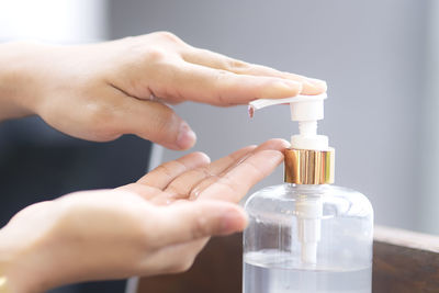 Close-up of hand holding glass bottle