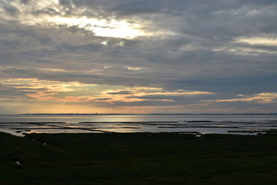 View of beach against cloudy sky