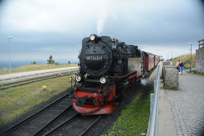 Train on railroad track against sky