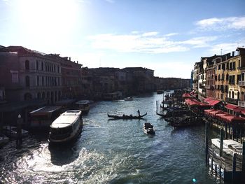 Boats in canal passing through city