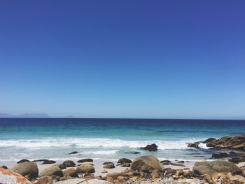 Scenic view of sea against clear blue sky