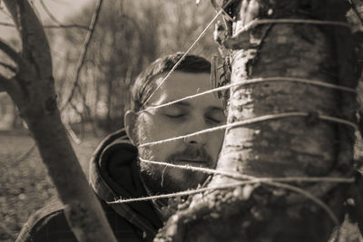 Portrait of boy looking through tree