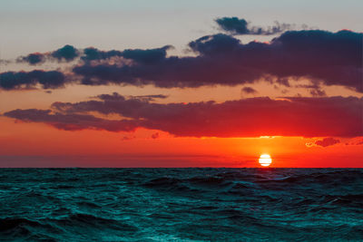 Scenic view of sea against orange sky
