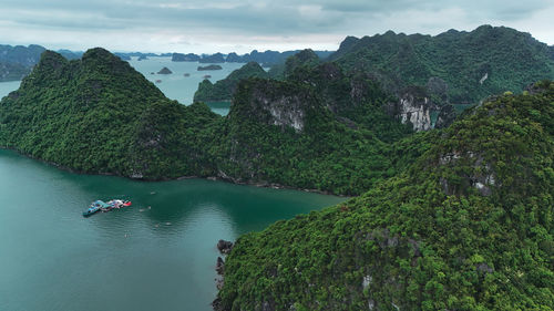 Scenic view of sea and mountains against sky