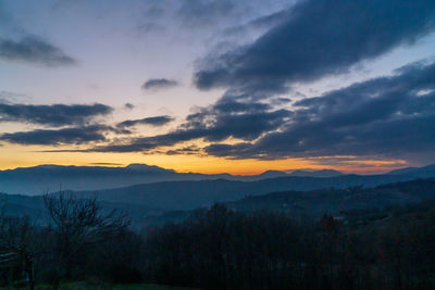 Scenic view of silhouette mountains against sky at sunset