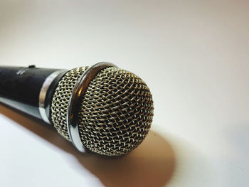 Close-up of camera on table against white background