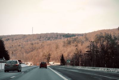 Cars on road against clear sky