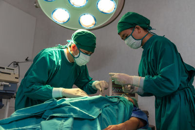 Surgeons doing surgery in operating room