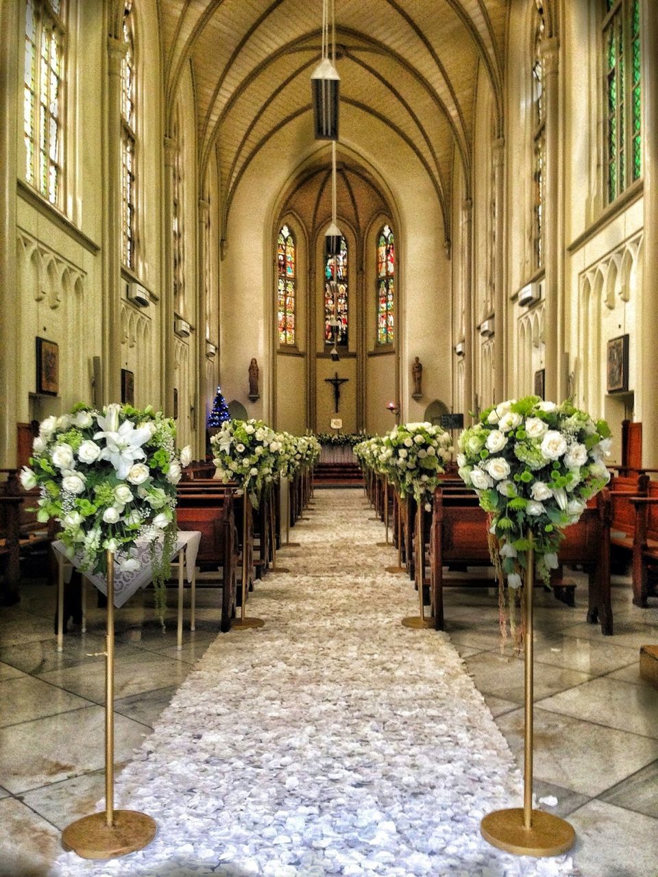 indoors, place of worship, religion, arch, spirituality, church, architecture, built structure, flower, potted plant, corridor, window, architectural column, day, plant, no people, pew, door