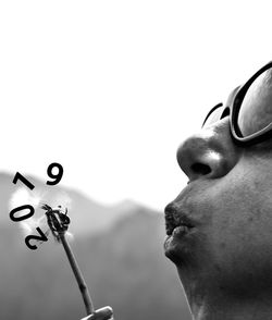 Close-up portrait of man against clear sky
