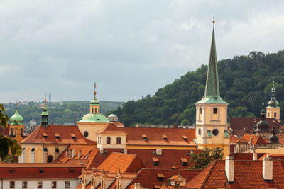 Lesser town buildings and rooftops with storm clouds. the medieval settlement of prague.