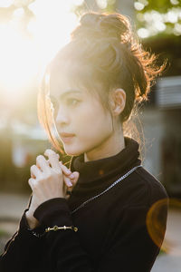 Portrait of young woman holding camera