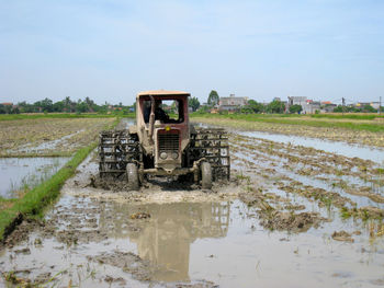 Tractor on field against sky