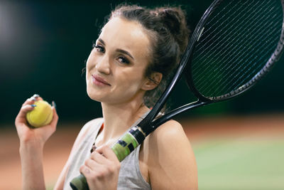 Portrait of tennis player holding racquet