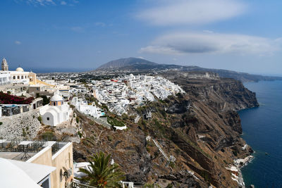 High angle view of townscape by sea against sky