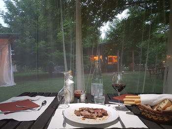 View of wine glass on table against trees