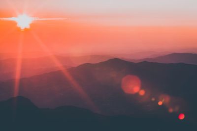 Scenic view of silhouette mountains against sky during sunset