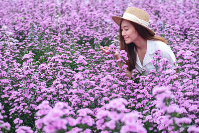 Portrait image of a beautiful young asian woman in margaret flower field