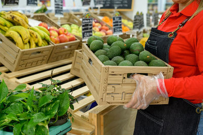 Midsection of woman holding fruit