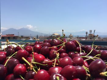 Close-up of cherries in water against sky