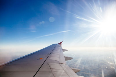 Airplane wing against blue sky