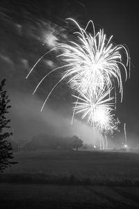 Low angle view of firework display at night