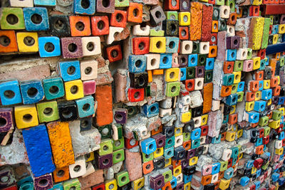 Full frame shot of multi colored toys against wall