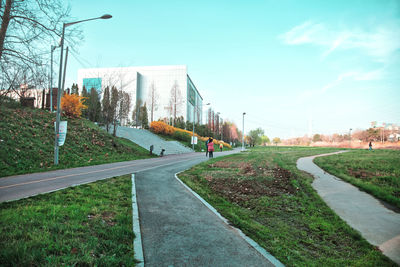 Road by city against sky