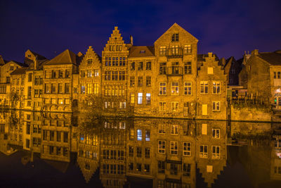 Reflection of building in water at night