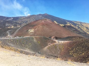 Scenic view of mountain road against blue sky