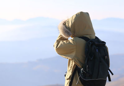 Person wearing jacket against sky