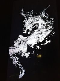 Close-up of water splashing against black background