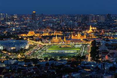 High angle view of illuminated buildings in city at dusk