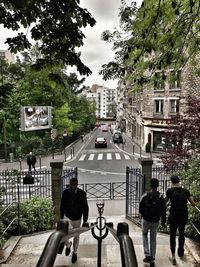 People walking on road in city