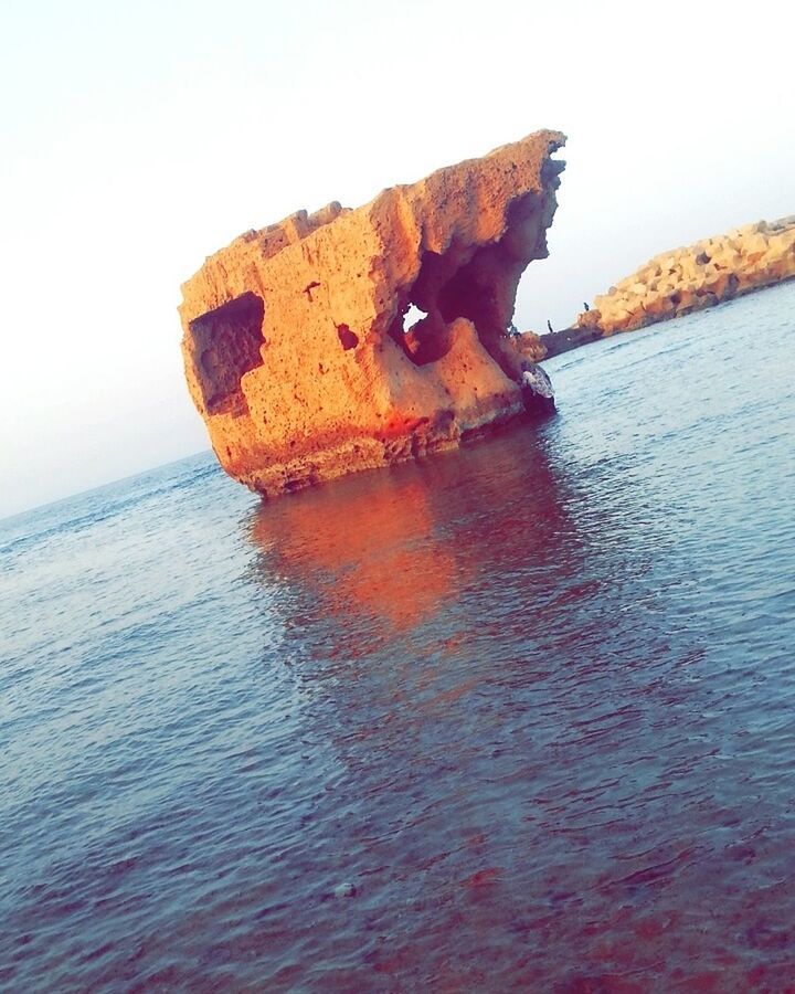 sea, water, nautical vessel, nature, rock - object, transportation, abandoned, waterfront, tranquility, beauty in nature, no people, scenics, sky, outdoors, rusty, beach, day, horizon over water, cliff, clear sky, sunken