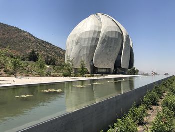 View of built structure by mountain against sky