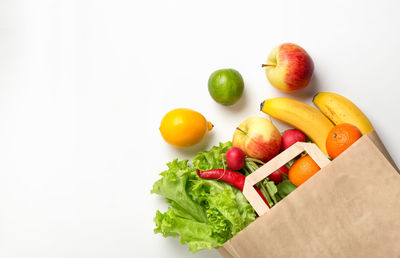 Close-up of fruits in plate against white background