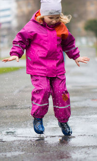 Full length of girl standing in rain