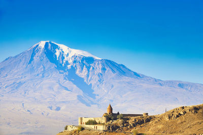 Scenic view of snowcapped mountains against blue sky