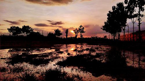 Scenic view of lake against sky during sunset