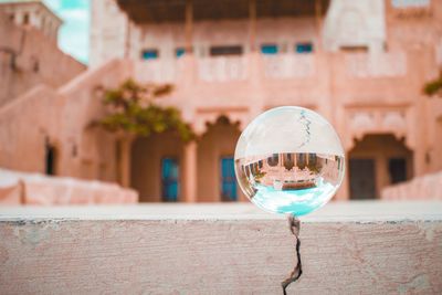 Close-up of crystal ball on glass wall