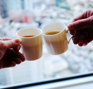 Cropped image of person holding coffee cup