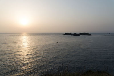 Scenic view of sea against clear sky during sunset