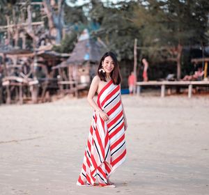Portrait of young woman standing outdoors