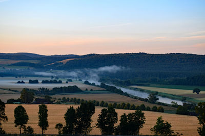 Scenic view of landscape against sky during sunset