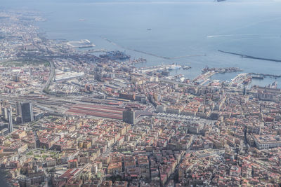 High angle view of townscape by sea against sky