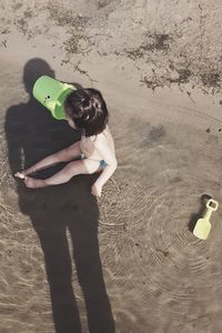 High angle view of girl playing on beach