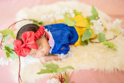 High angle view of cute girl sleeping on bed