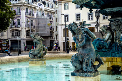 Rossio square and statue fountain in lisboa old town. lisbon, portugal